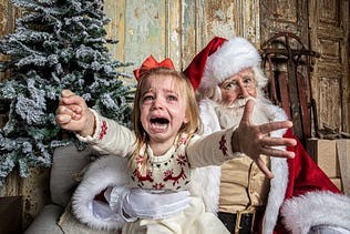 child crying on santas lap